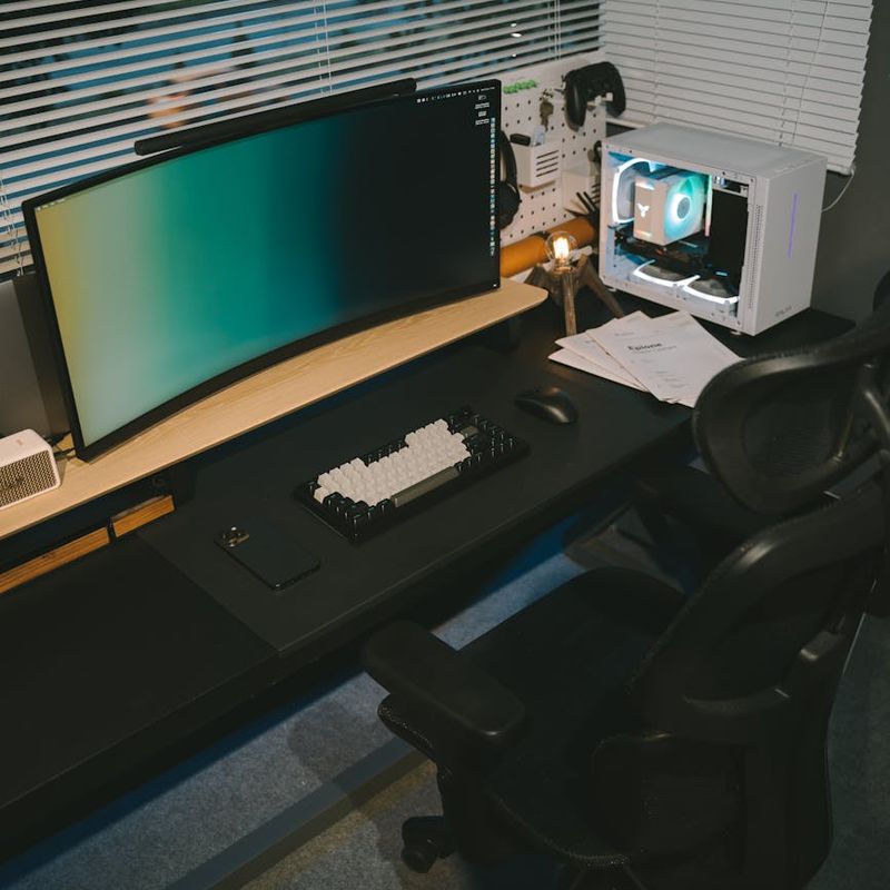 A person doing a light stretch at their home office desk, integrating movement into their day.